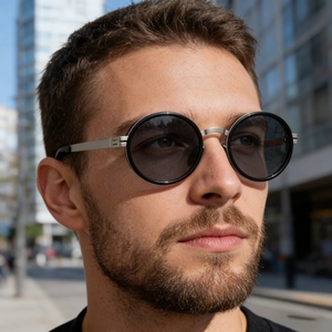 Close-up of retro oval polarized sunglasses with black frames and silver metal bridges