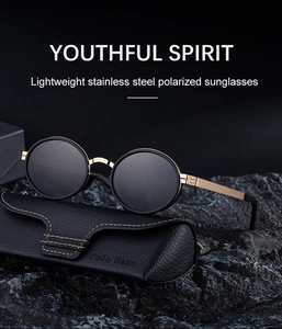 Detail of vintage polarized oval sunglasses with gold stainless steel frame on a leather case