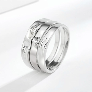 Set of three silver polished stackable rings with fluid flame texture and zircon inlay