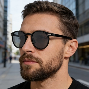 Men's retro oval polarized sunglasses with black metal frame shown on male model