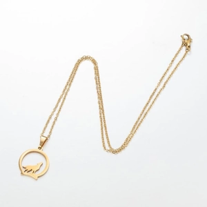 Close-up of golden stainless steel wolf pendant with intricate hollow cut-out design