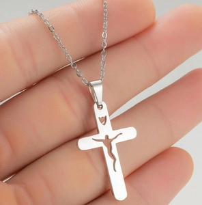 Detailed close-up of a silver stainless steel cross pendant with hollow Jesus design