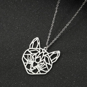 Macro shot of silver geometric tiger head pendant on delicate chain over dark texture