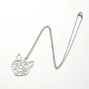 Macro detail of a silver-colored stainless steel hollow cat pendant on a fine link chain