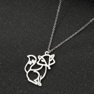 Macro shot of silver fox pendant necklace with hollow wireframe design on black background