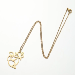 Detailed view of a gold-toned hollow cat pendant necklace with a secure lobster clasp