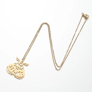 Macro shot of gold moth pendant with geometric cutouts on a delicate link chain necklace