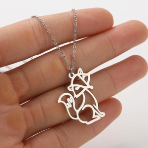 Close-up of minimalist stainless steel fox pendant with geometric hollow-out design