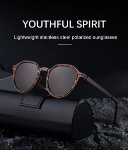Detail of polarized round sunglasses with tortoise frame and leather case on rock