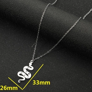 Detail of silver snake pendant with moon engraving and dimensions 26mm by 33mm