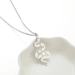 Minimalist silver stainless steel snake pendant necklace with moon cutout design