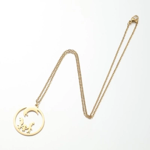 Macro view of gold family circle pendant with moon and abstract silhouettes on fine chain