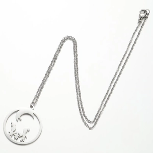 Silver geometric necklace with moon and family silhouette pendant on gray background