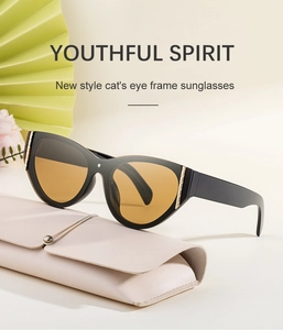 Close-up of cat-eye sunglasses with gold metal accents on a pink leather case