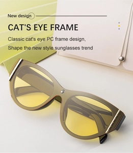 Detailed view of olive green cat-eye sunglasses with yellow lenses and gold metal accents