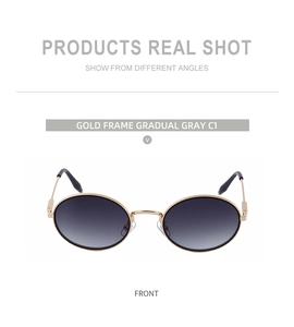 Gros plan de lunettes de soleil en métal doré avec verres dégradés gris et design ovale