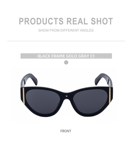 Macro detail of black cat eye sunglasses with gold metallic accents on the hinges