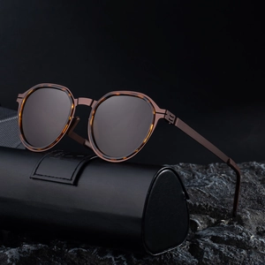 Retro polarized sunglasses with tortoiseshell frames and metal temples on a leather case