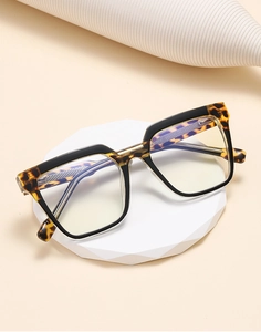Detail of square oversized glasses with tortoiseshell pattern and black stitching
