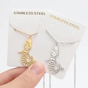 Detailed close-up of gold and silver mermaid pendants made of durable stainless steel
