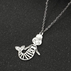 Detailed view of silver mermaid pendant with 18K gold plated chain on black background