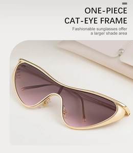 Detail of one-piece cat-eye sunglasses with gold metal frame and gradient purple lenses