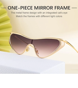 Detail of trendy one-piece cat-eye sunglasses with gold metal frame and gradient lenses
