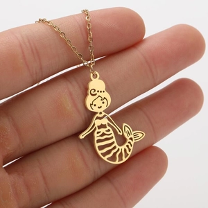 Close-up of 18K gold mermaid pendant necklace held in hand with hollow design
