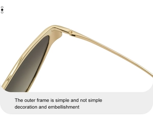 Detail shot of golden metal hinges and dark gradient lenses on cat eye sunglasses