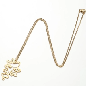 Detail of gold stainless steel necklace featuring a minimalist sun face cutout pendant