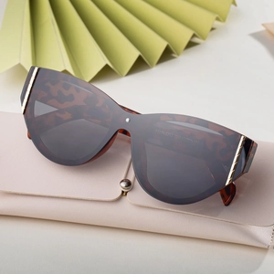 Women's cat eye tortoise shell sunglasses with dark brown lenses and gold metal accents