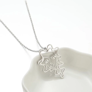 Minimalist stainless steel necklace featuring abstract face line art pendant on silver chain