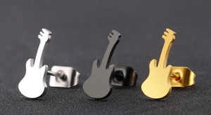 Detailed macro view of electric guitar stud earrings in silver, black and gold plated finish
