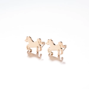 Close-up of polished gold horse stud earrings with a glossy silhouette finish