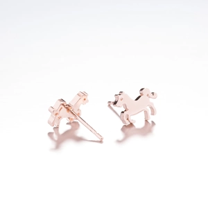 Macro shot of rose gold animal horse stud earring with polished metallic finish
