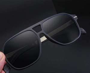 Detail of matte black sunglasses with silver arrow hinge and product model DB7104