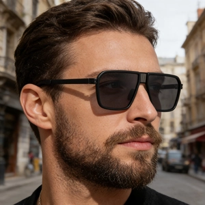 Detail of vintage square sunglasses with textured metal double bridge and dark lenses