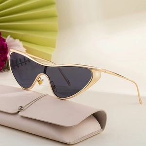 Cat-eye sunglasses with gold metal frame and dark lenses, presented with a leather pouch