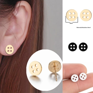 Detail view of 8mm stainless steel button stud earrings in gold, silver, and black finishes
