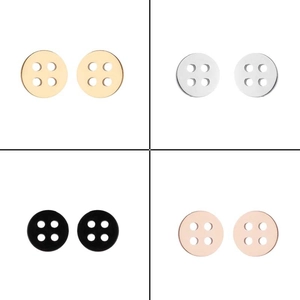 Detail view of round button stud earrings set in gold, silver, black, and rose gold finish