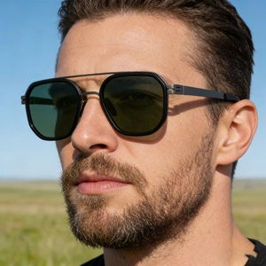 Detail of square double-bridge polarized sunglasses with matte black frames and dark green lenses
