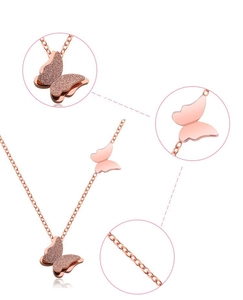 Detail of rose gold double-layered butterfly necklace with frosted and polished finish
