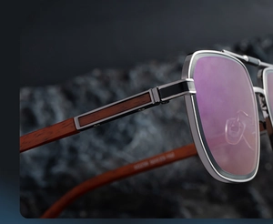 Detail of square sunglasses showing silver hinges and retro wood grain temples