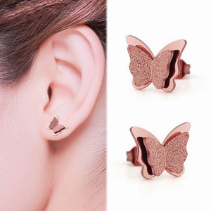 Detail of rose gold double-layered butterfly stud earrings with frosted glitter finish