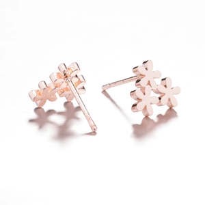 Polished rose gold flower stud earrings featuring three cluster blossom petals