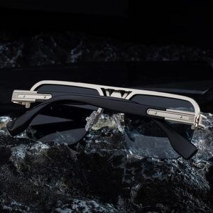 Detail of semi-rimless sunglasses showing double bridge and textured metal hinge