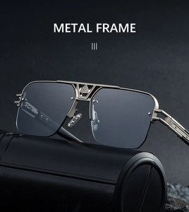 Detail of gunmetal frame sunglasses with a hollow bridge design and dark grey lenses