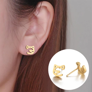 Detail view of gold hollow cat stud earrings showing secure backing and polished finish