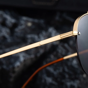 Detail of pilot sunglasses showing high-quality gold metal frame and hinge craftsmanship