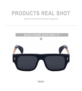Front view of square sunglasses featuring a black frame with gold temples and grey lenses